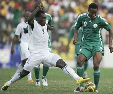 Nigeria midfielder John Obi Mikel (right) is challenged early on by his Chelsea team-mate Michael Essien