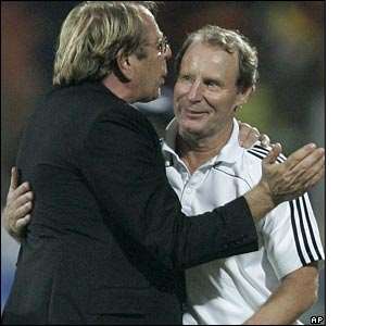 The coaches embrace at the final whistle, but Nigeria's exit will increase the pressure on coach Berti Vogts (right)