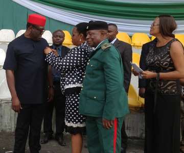 Imo Deputy Gov. Prince Eze Madumere, MFR, being decorated by the Hon. Comm. for Women Affairs and Social Development, Lady Love Nma Onyechere while the President of the Nigerian Legion, Lt. Col. D. N. Okafor (Rtd) looks on the the Emblem Appeal Fund Launching at Heroes Square, Owerri, Imo State