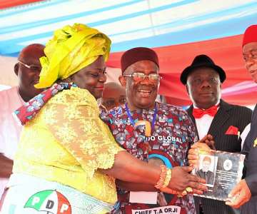 Gov. Theodore Orji of Abia state receiving an award of''''ICON OF PUBLIC SERVICE'''' from Lady Adanma Iheuwa, PermanentSecretary Abia state Planing Commission during a grand civic receptionorganised by Abia state Public Servants in honour of the governor inUmuahia. Watching are Barr. Godson Adiele, Head of Service Abia state(middle) and Chief Emeka Wogu, Minister for Labour and Productivity(far right).