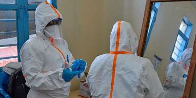 WHO Health workers prepare for work at a newly-opened Ebola treatment centre in Bunia, DR Congo
