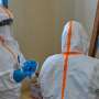 WHO Health workers prepare for work at a newly-opened Ebola treatment centre in Bunia, DR Congo