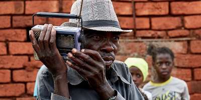  A displaced Congolese man listens to the radio outside his shelter in South Kivu province in January. Journalists have been targeted for reporting on the latest clashes. (Photo: Reuters/Gradel Muyisa Mumbere)