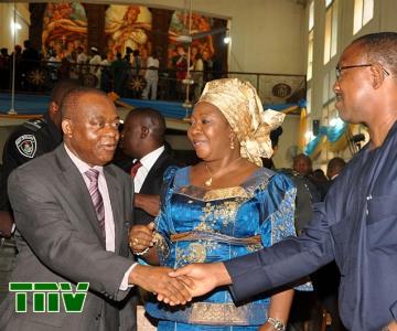 Gov. Theodore Orji of Abia state in a handshake with his Anambra state counterpart Gov. Peter Obi at a Church service marking the conference of catholic bishops'' of Nigeria in Umuahia, watching is Chief Mrs Mercy Odochi Orji, wife of Abia state governor.